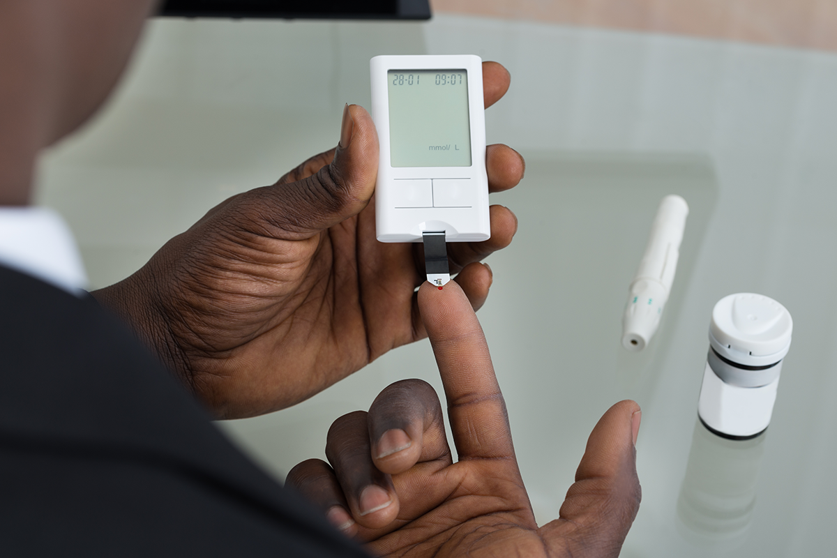 man testing blood sugar