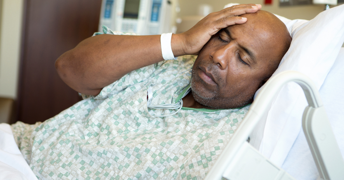 man laying in a hospital bed sick